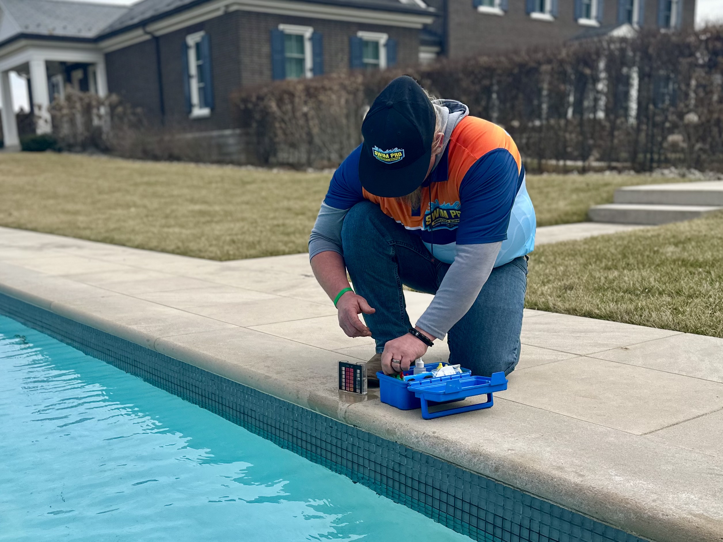 Swim Pro technician testing pool water in Lexington